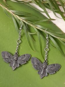 earrings featuring a death moth motif