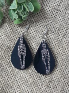 teardrop shape earring s featuring a skeleton
