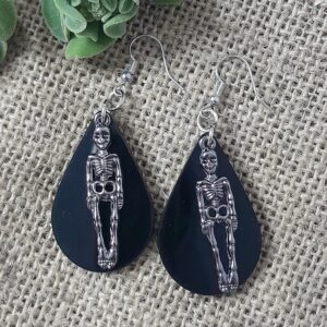 teardrop shape earring s featuring a skeleton