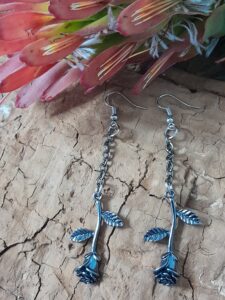 dangle earrings featuring upside down rose piece