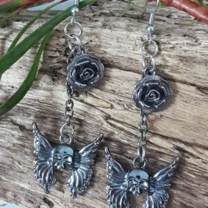 Earrings with surgical steel hooks featuring skull butterfly and rose metal alloy pieces
